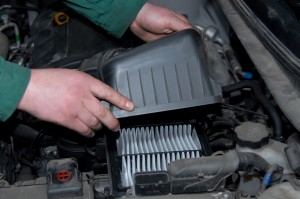 A mechanic working on an air filter